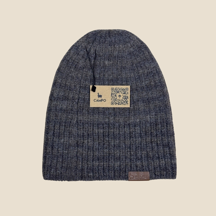 Blue knit beanie with a 'Campo' label on a beige background