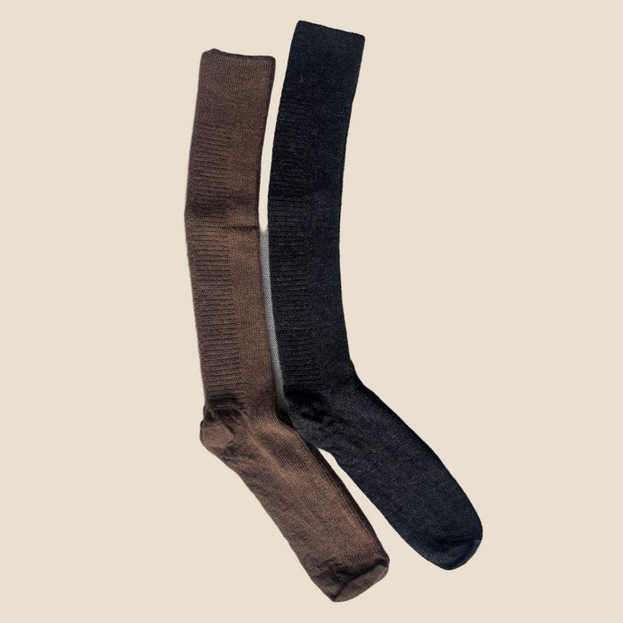 Brown and black knee-high socks on a textured gray surface
