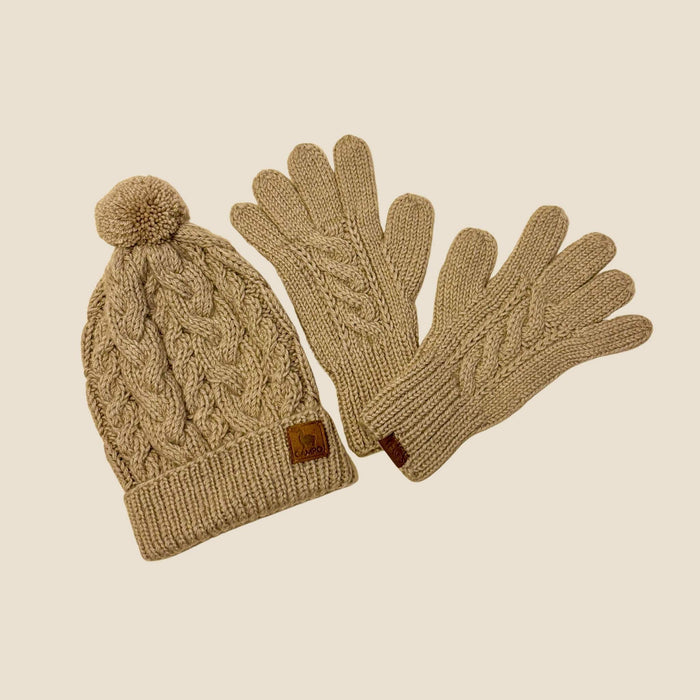 Knitted beige hat and gloves set on a beige background