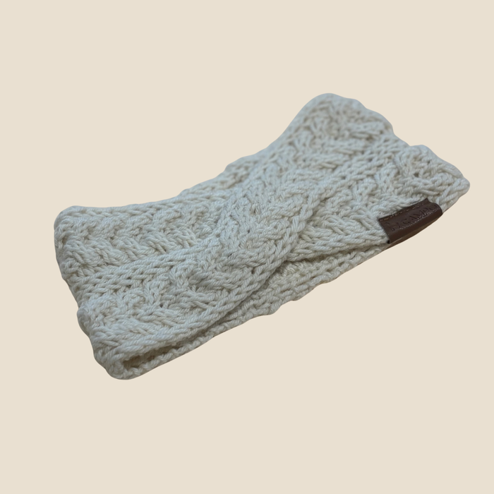 Knitted headband on a beige background