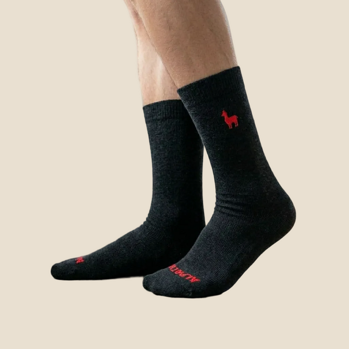 Black socks with red logo and text on a beige background