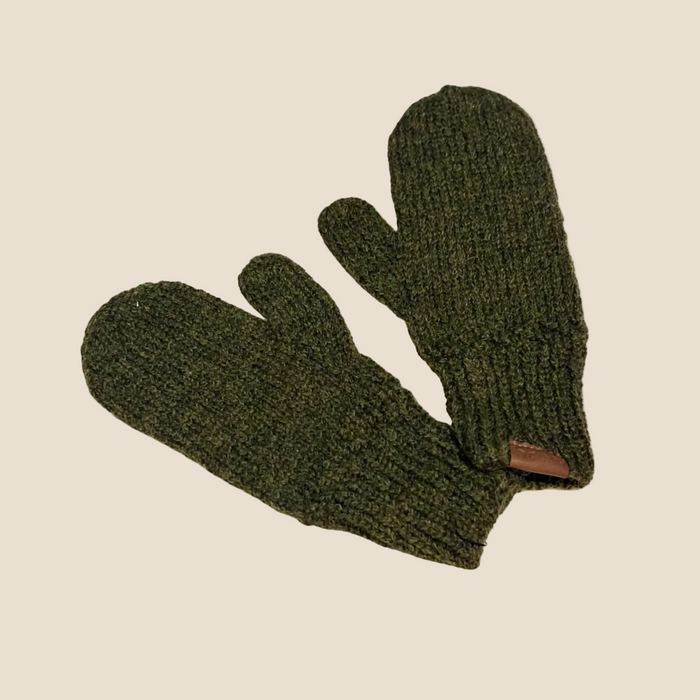 A pair of dark olive green ribbed knit mittens on a solid cream-colored background.