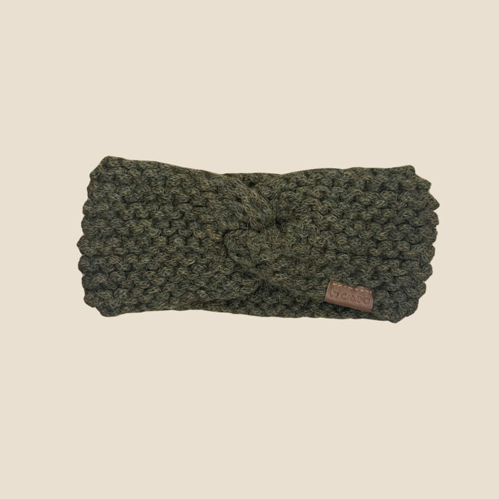 Olive Green knitted headband with a brand label on a beige background