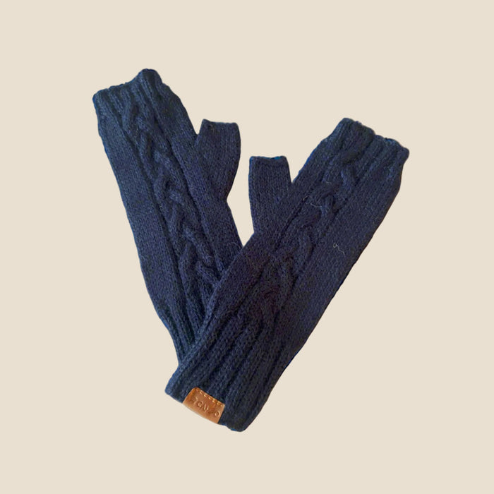 Pair of blue knitted fingerless gloves on a beige background