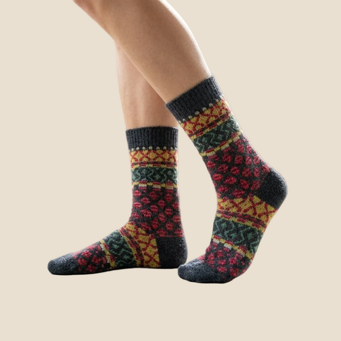Colorful patterned socks worn by a person indoors.