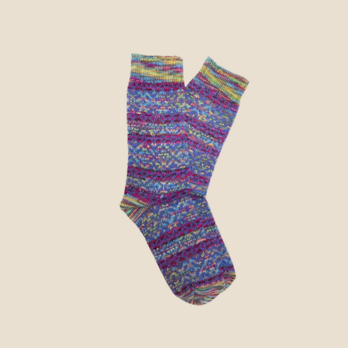 Colorful knitted sock on a beige background