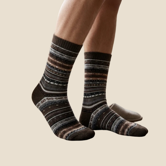 Person wearing patterned socks in a home setting
