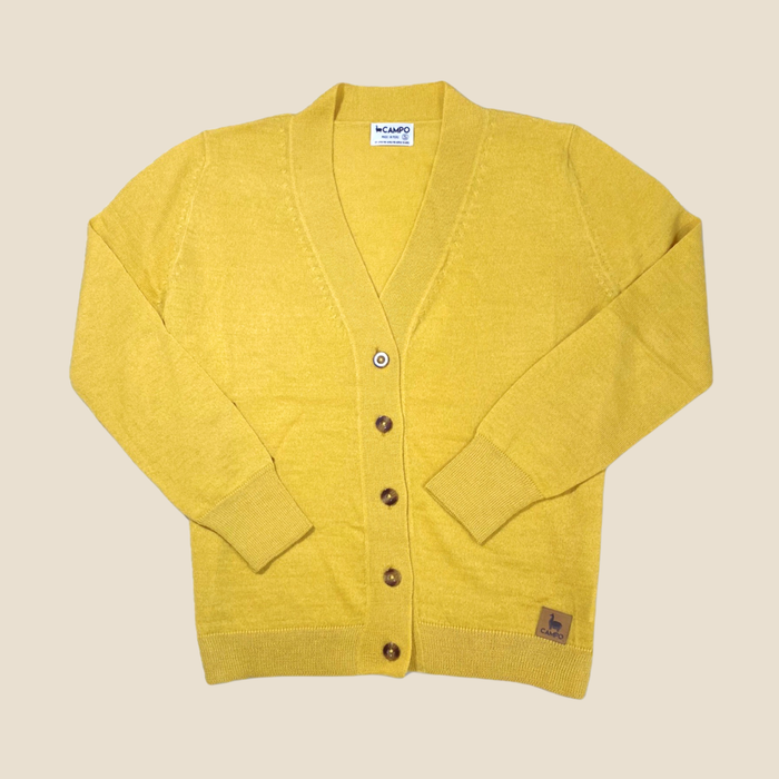 Mustard cardigan with brown buttons on a beige background