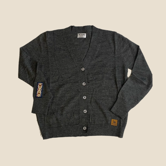 Dark gray cardigan with button details on a beige background
