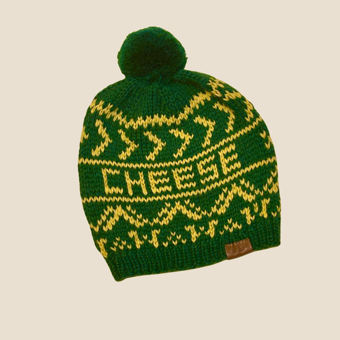 Campo Alpaca Cheese Beanie laid flat on a white background, featuring a soft green  alpaca