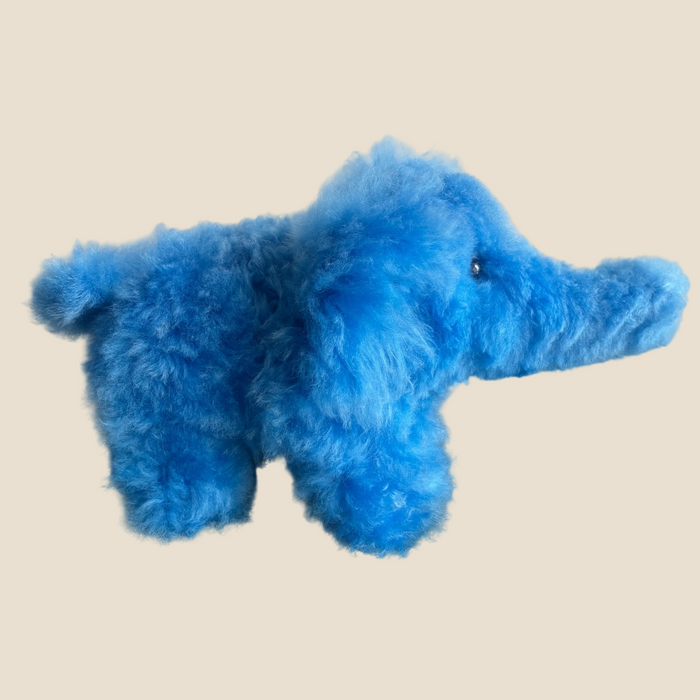 Blue plush toy on a beige background