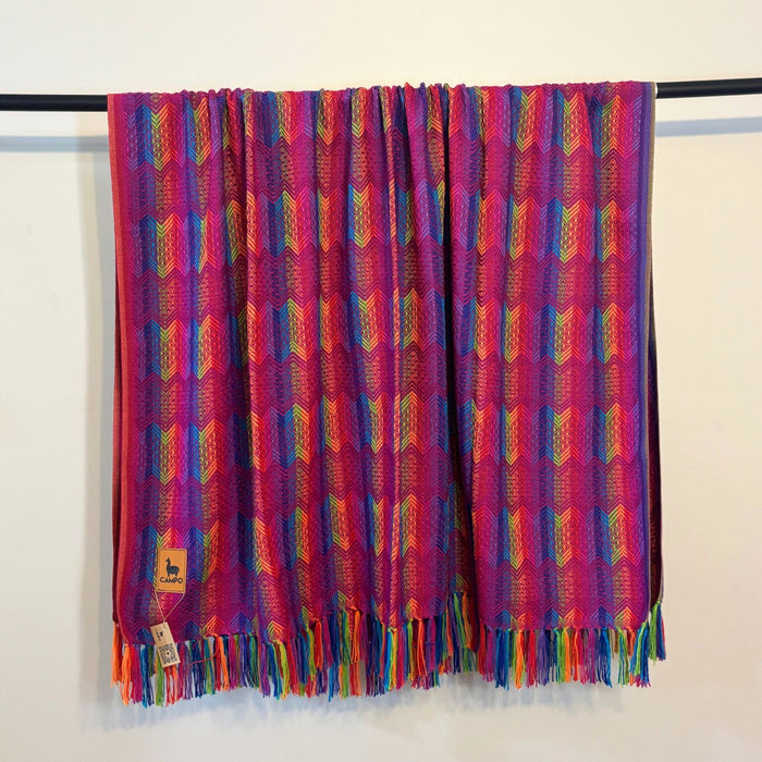 Colorful patterned scarf with fringes on a white background