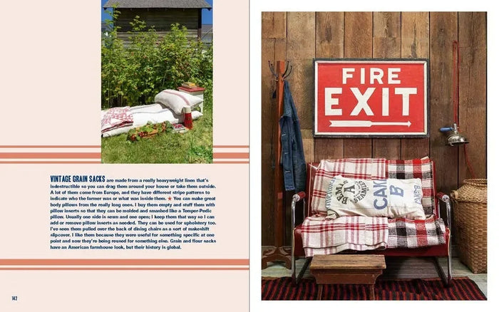 Vintage-style interior with plaid blanket, pillows, and 'Fire Exit' sign.