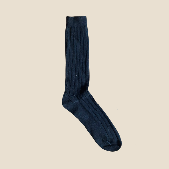 Black sock on a beige background