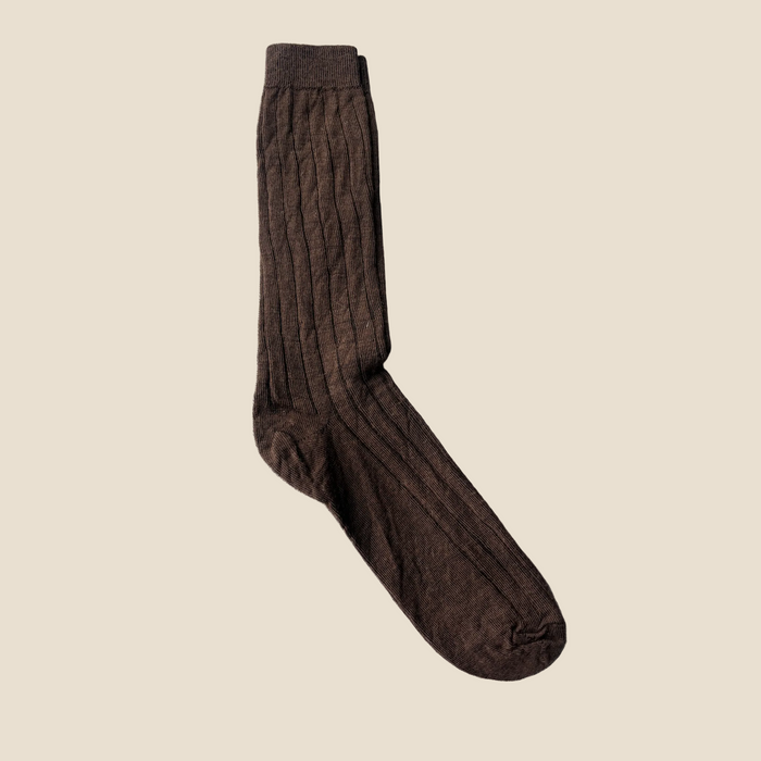 Brown sock on a beige background