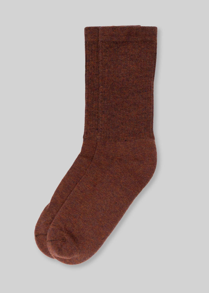 front brown wool socks on light grey background