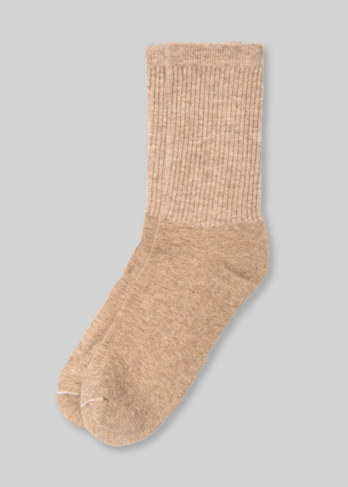 c2e41e6bcbac1de70c0f5df62aeeec654601ec90f1e00a2f41370a95004d8cab front beige ribbed crew sock on gray background