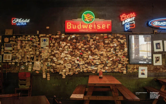Wall covered with notes and business cards, neon beer signs, rustic bar interior décor