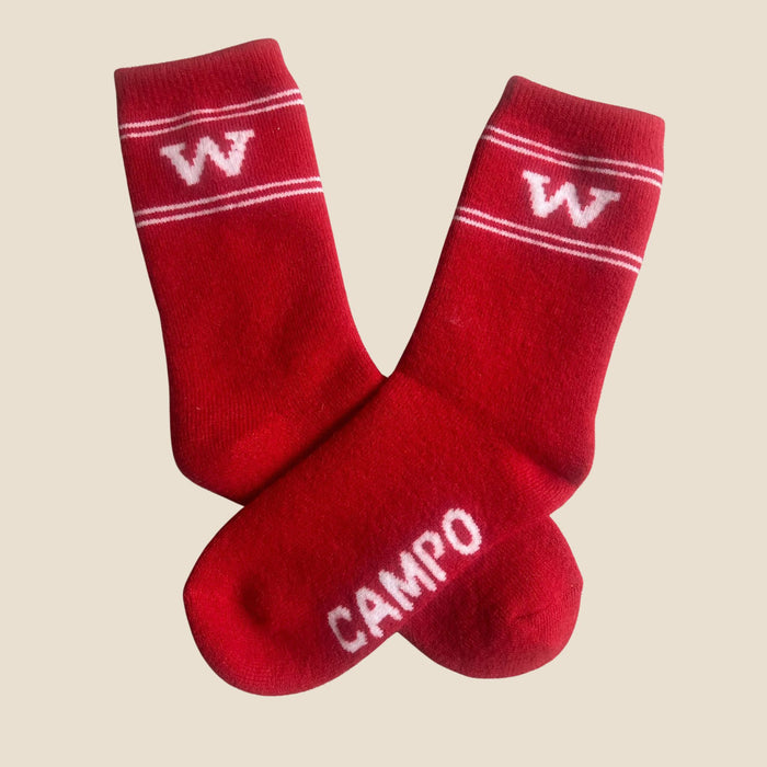 Red socks with white lettering on a beige background